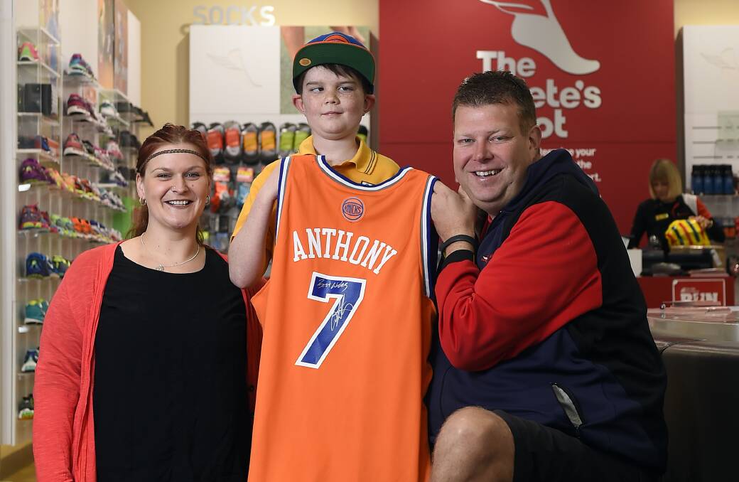 The Athlete’s Foot Ballarat owner Paul Tudorovic presents Jaxon Cooper with a signed New York Knicks singlet and game tickets while Leonie Coad has organised a fund-raiser to help send Jaxon’s whole family over for the game.