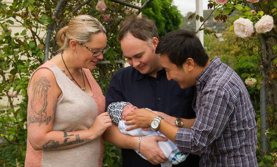 Mel Wells with Dwane Thorne-Kim and Noah Kim and their son Oliver Thorne-Kim, who Ms Wells carried as a surrogate. Picture: Scott Gelston
