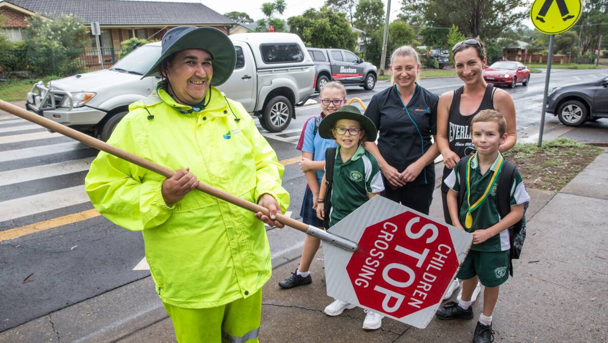 'Lollipop lady' Tucky Cooley at Freemans Reach Public School with: Amy and Jayden (6) Miller; and Nicole, Jasmine (12) and Paige (9) Barlow. Picture: Geoff Jones