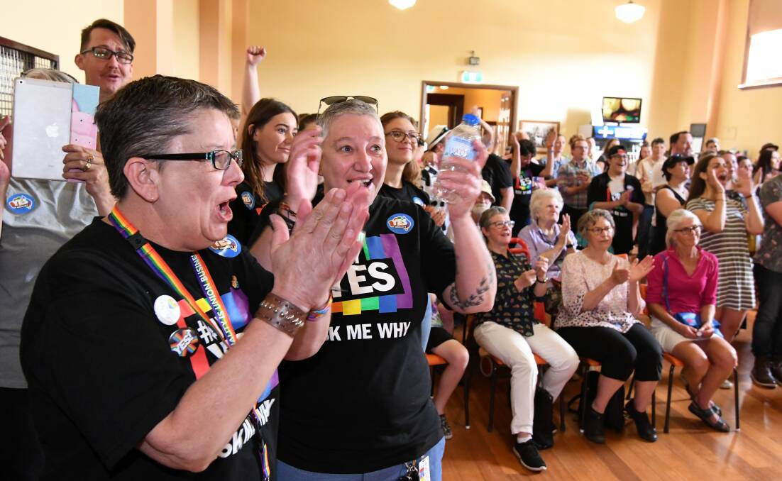 YES: Jen McInerney, Janine Fleming, and the crowd at Ballarat Trades Hall react to the news of the marriage equality postal survey results. Picture: Lachlan Bence. 
