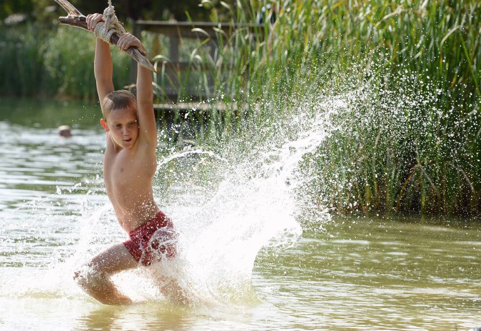 MAN OF ACTION: Matt Birkett takes advantage of the cool waters of Lake Esmond to cool off. 