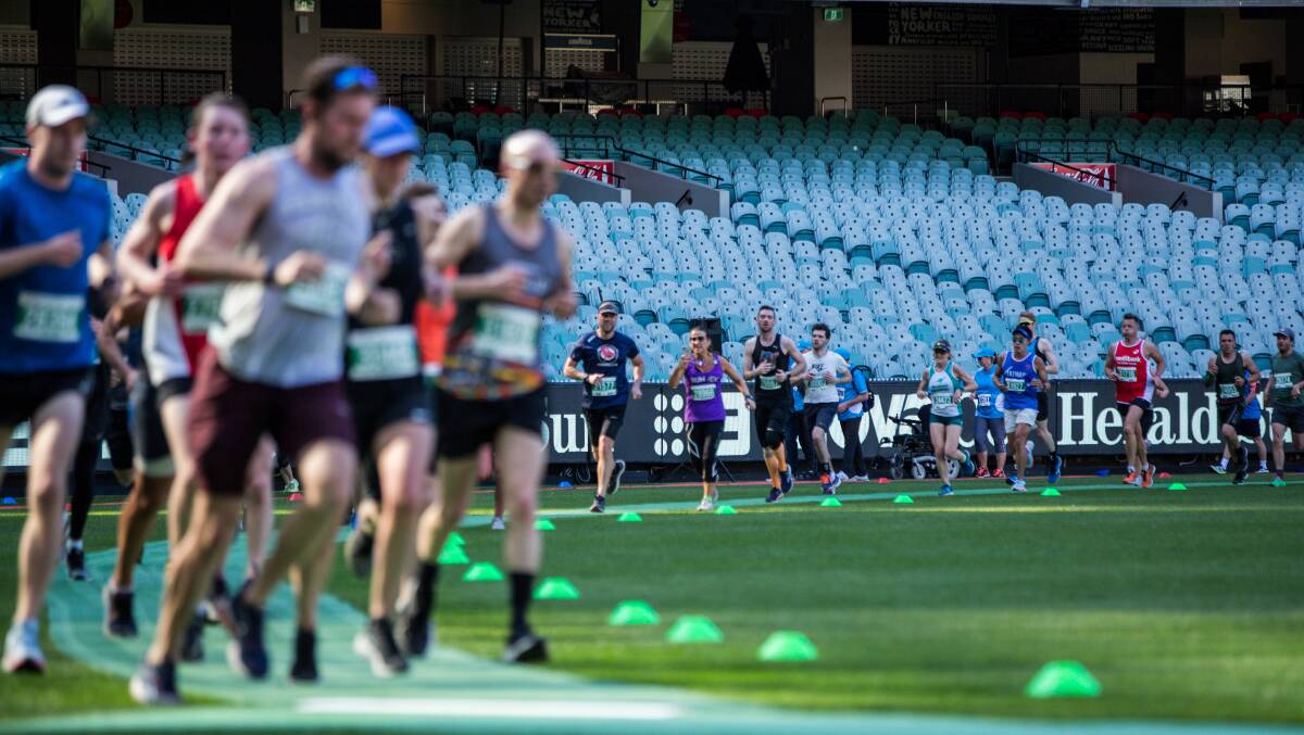 G WHIZ: Runners end the marathon with a lap of the Melbourne Cricket Ground.