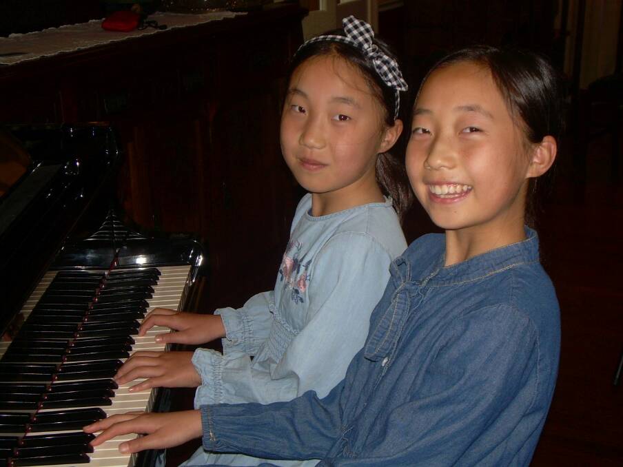 Minna and Claire Wu at the piano.