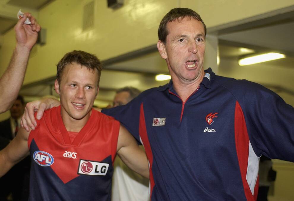 James McDonald celebrates with coach Neale Daniher after a win in 2003, a period when the Demons were often close to knocking on the door of AFL finals. Picture: Getty Images
