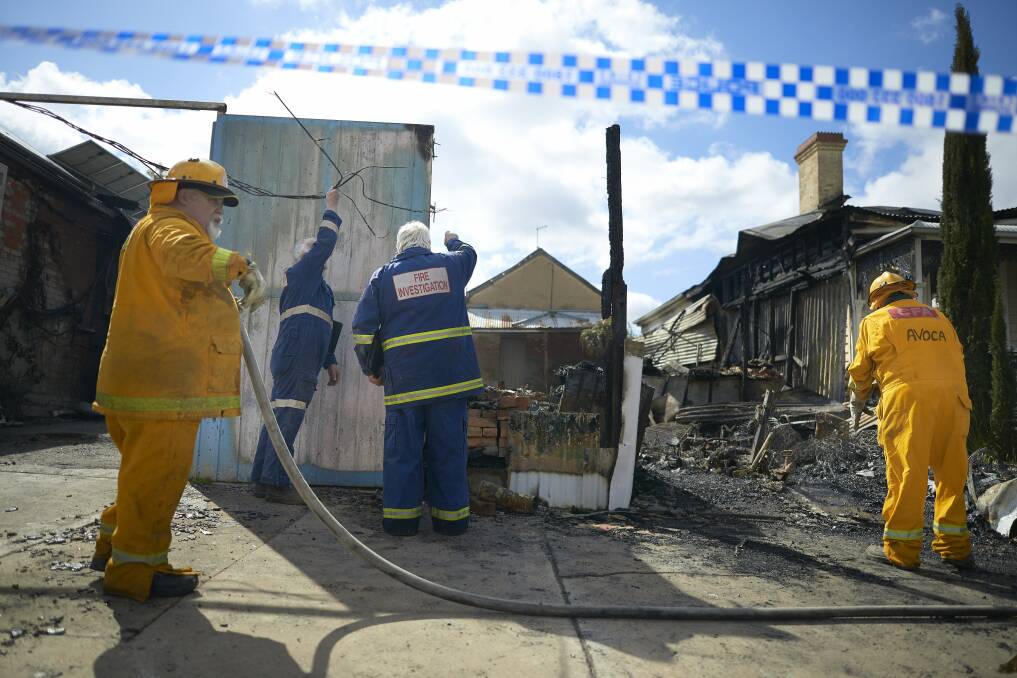 FIREFIGHTERS: Avoca CFA members douse the remains of the bakery.