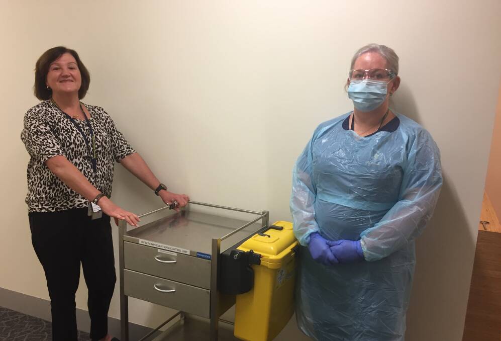 READY: Ballarat Health Services Manager infection, prevention and control and workforce immunisations manager Sue Lockhart, left, and a colleague.in personal protective equipment. Picture: supplied 