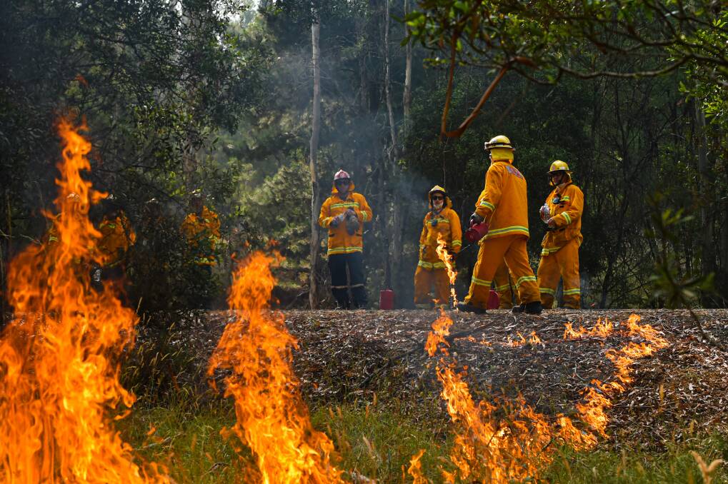 Crews work on fire break burns near Corryong Picture: Jason Edwards