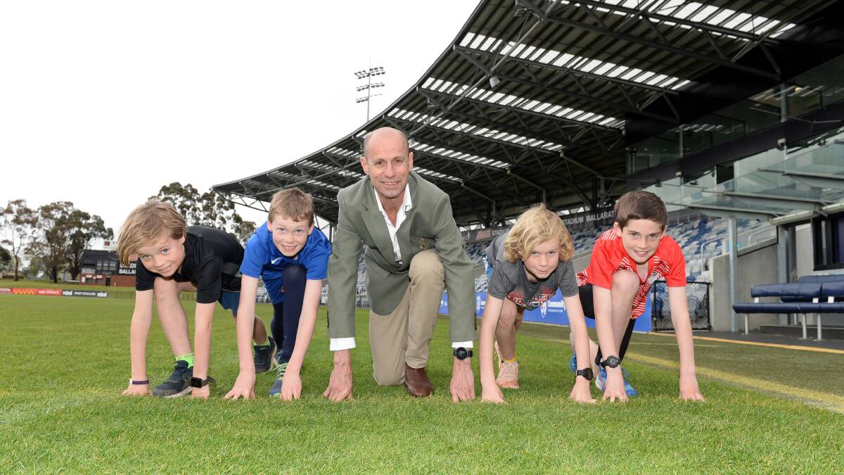 OFF and running: Steve Moneghetti with a some enthusiastic young athletes at the Commonwealth Games announcements today. Picture Kate Healy