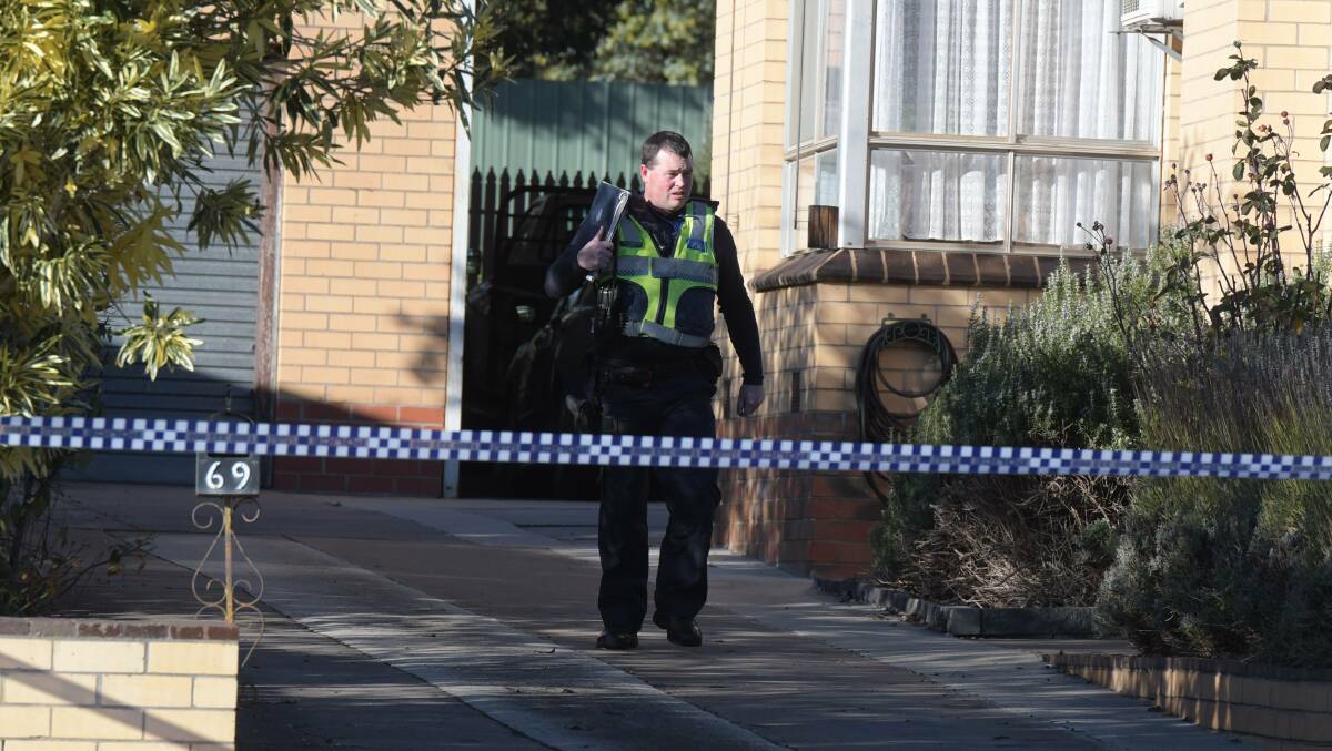Police outside the home where John Bourke was found dead.