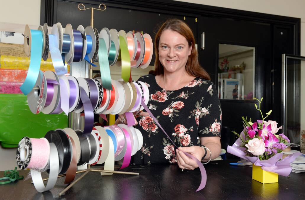 COMMUNITY SUPPORT: Julie Collins, Boronia Exclusive Florists owner has shown her solidarity with survivors of sexual abuse by offering ribbons to the Loud fence movement. Picture: Kate Healy