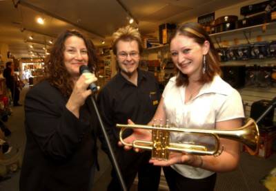 HELPING  A FRIEND: Local musician Kathie Lewicki, left, with Ballarat University  student Suzi Koene, right, who had her trumpet stolen, and Allans Music staff member Richard Kornas,    promote the  fundraising night at the Creswick Farmers Arms Hotel later this month to help Suzi raise money to replace her much-needed musical instrument.