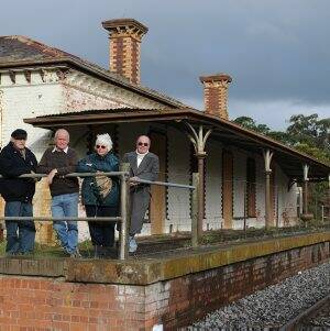 HAPPIER TIMES: Clunes residents Tom Binns, Richard Gilbert, Maureen French and Satch Niemiec standing on the Clunes Railway Station platform last year. The platform has been revamped but the iconic verandah is missing.