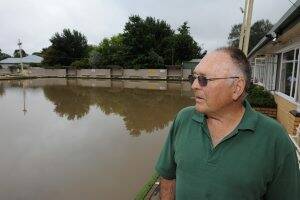 NOT AGAIN: Creswick Bowling Club president Barry Yates inspects the damage after last month's deluge