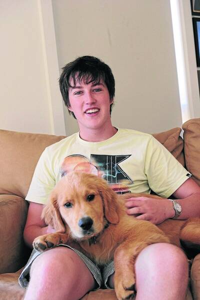 FEELING OK: Nic Johnston with golden retriever pup Banjo, waiting for his university course offer, due out tonight. Picture: Zhenshi van der Klooster