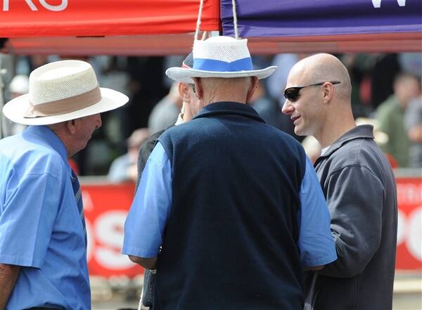 WHAT DO YOU THINK?: Victorian Athletic League board member Rob Lehmann, of Ballarat, right, talks with fellow VAL officials midway through the Stawell Gift heats about possible problems with the length of the track.