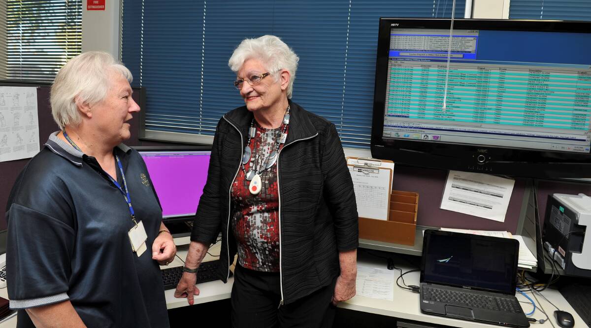 SAVING LIVES: Safety Link operator Glenise Miller, left, discusses the monitoring system with client Patricia Harvey. PICTURE: LACHLAN BENCE