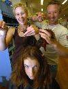 CUT FOR CAUSE: Peter Ludbrook of Touche Fine Hairdressing and Jessica Browning of Stranded on Peel give Temeika Armstrong's hair the chop to support the Wright-Burrell Appeal.