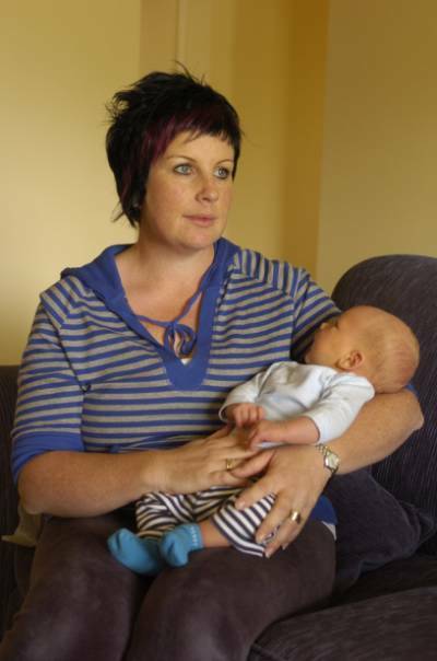 SELFLESS: Fiona Miles cradles her son Spencer. Ms Miles was 29 weeks pregnant when she underwent surgery last October to save younger sister Simone Wignall's life. Picture: Lachlan Bence