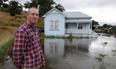 Wes Peters happy that his mother's house was safe from flood waters. Picture: Lachlan Bence