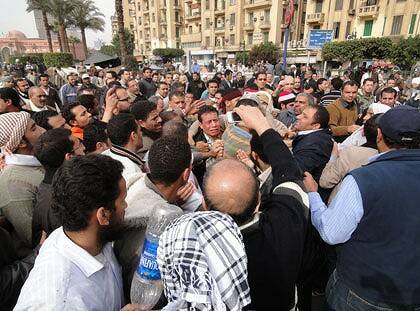 Mob rule ... a man suspected of being a policeman is mobbed in Tahrir Square.