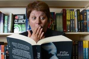 GOLLY GOSH: Ballarat Books staff member Helen Holyoak checks out Fifty Shades of Grey. PICTURE: ADAM TRAFFORD.