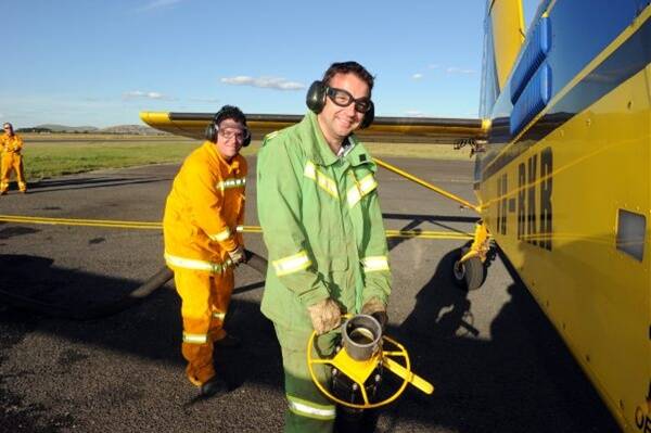 Wedouree CFA firefighter Shaun Russell and the DSE's Damian Sharrock loading the Airtractor 802 as part of the training at the Ballarat Airport. Picture: Zhenshi van der Klooster