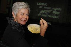 OLD TIMES: Ballarat City councillor Judy Verlin enjoys some popcorn in the Brittania Theatre of the Ballarat Mechanics’ Institute where movie trailers will be showing during Ballarat Heritage Weekend. 