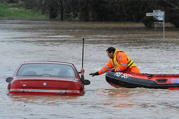 SES workers rescue a driver trapped in flood waters at Creswick. Picture: Jeremy Bannister