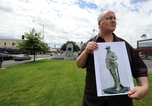 vision: Sculptor Louis Laumen with a photograph of his model of the Pompey Elliot statue.