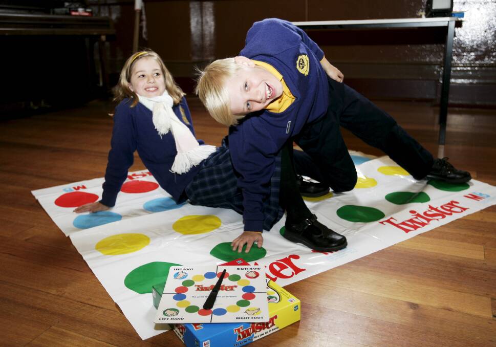 TWISTING THE DAY AWAY: Remi and Jett Currie try a game of Twister. PICTURE: CRAIG HOLLOWAY.