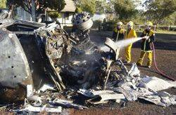 SO CLOSE: The smouldering wreckage of the petrol tanker lays just metres from a Sailors Falls house.