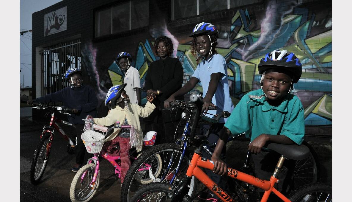 YMCA Re-cranked Recycles program restores second hand bikes for kids. Changkuoth Tharjiath, 12, Chudiar Tharjiath, 14, Nyabuul Tharjiath, 4  Mary Tharjiath , Kim Chol, 17, Buay Tharjiath, 9. 