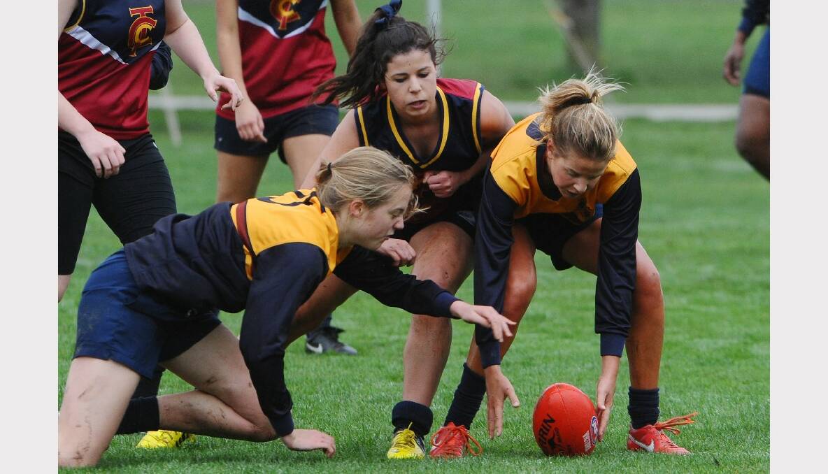 Herald Sun Shield girls football semi-final  Ballarat Grammar  v Thomas Carr College. Grammar- Nina Cowie, TC- Maddison Eade and Grammar- Clara Toohey. PHOTO: KATE HEALY.