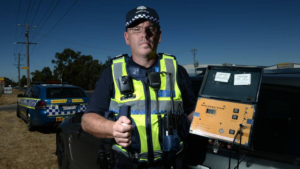 OLD SCHOOL: Ballarat Highway Patrol Acting Sergeant Travis Johnson uses a Digitector to catch speeding motorists in Wiltshire Lane. PICTURE: ADAM TRAFFORD