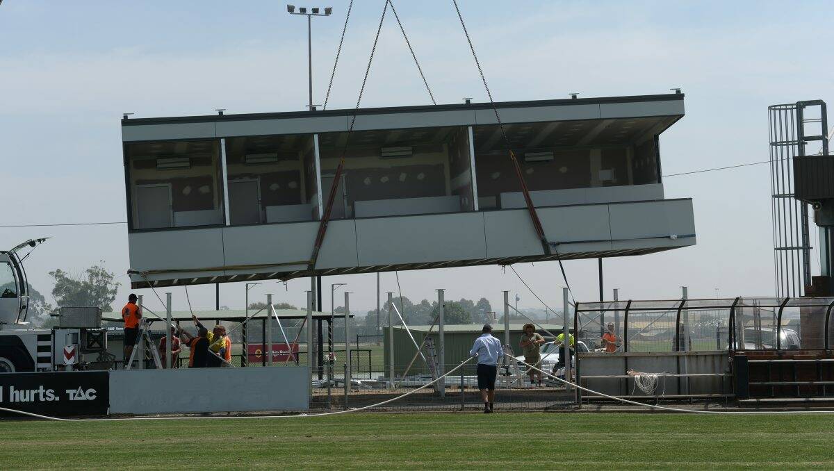 UPGRADE: The new coach's box is lowered into place at Eureka Stadium. PICTURE: ADAM TRAFFORD