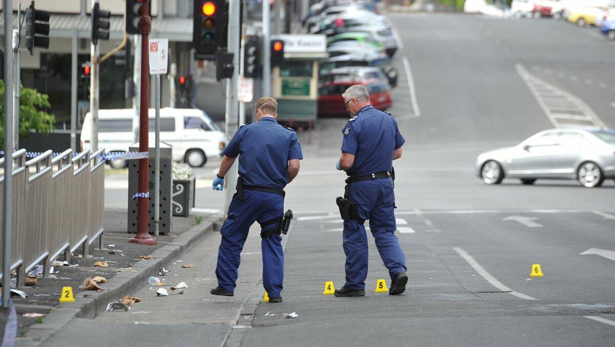 Police investigate the scene of Sunday morning's attack