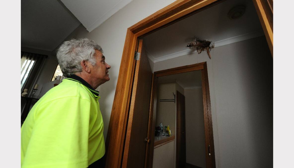 Graeme Smith looks at the storm damage inside his Marina Drive house. PICTURE: LACHLAN BENCE.