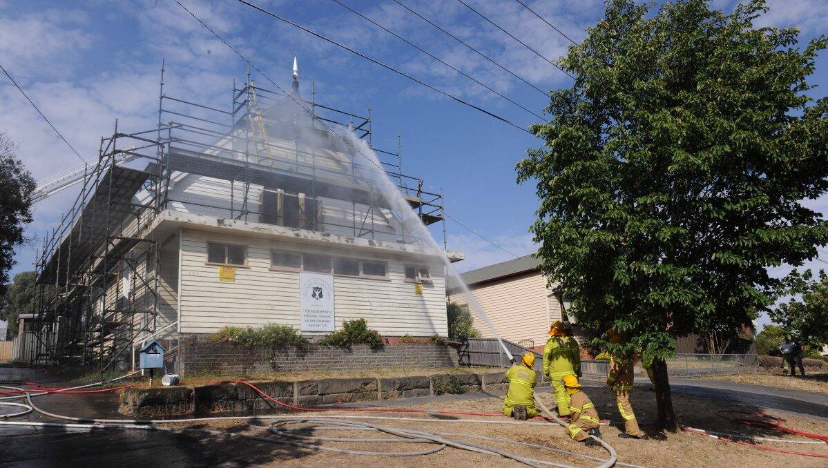 Firefighters tackle the blaze at the old church. PIC: Lachlan Bence