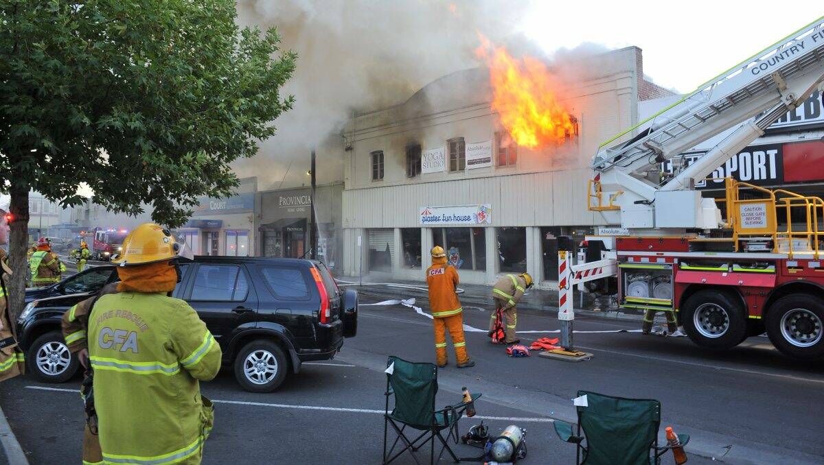 Firefighters battle last night's blaze as onlookers struggle believe their eyes. PIC: Lachlan Bence