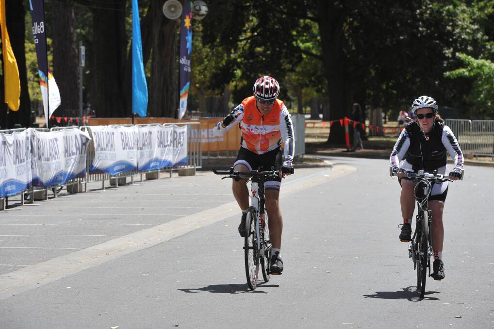 Road cyclists cross the line. PIC: Lachlan Bence