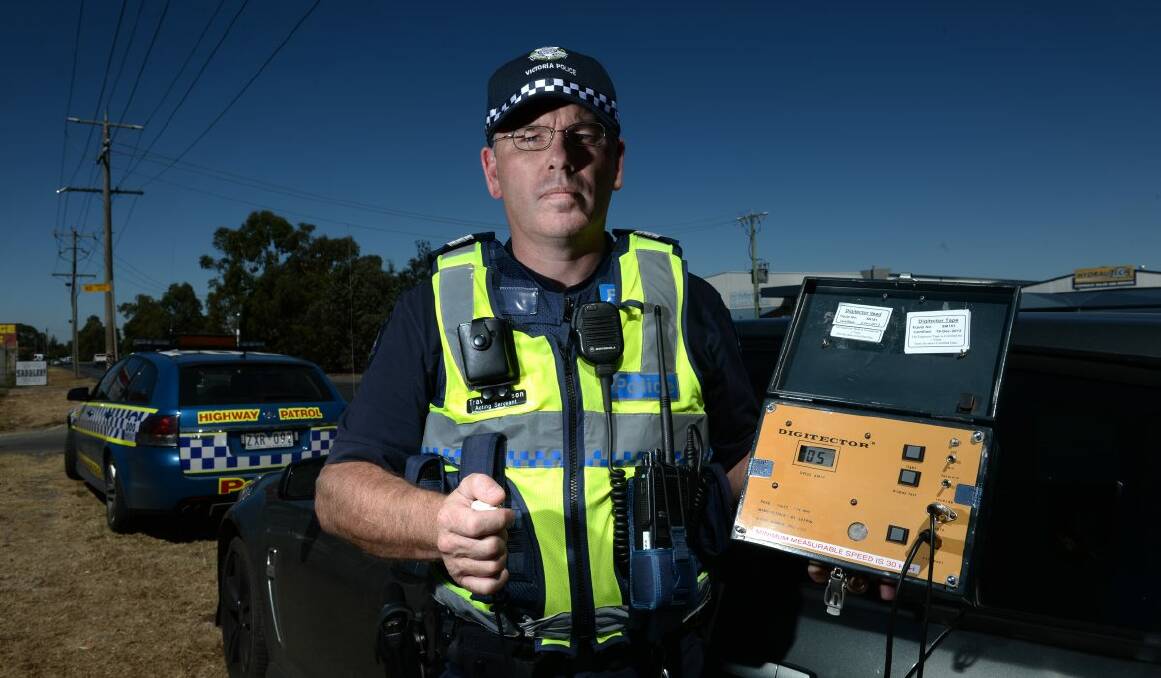 Acting Sergeant Travis Johnson tries out the Digitector speed detector. Picture: Adam Trafford
