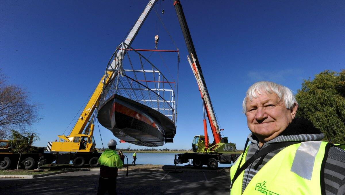 George Brookes watches his pride and joy lowered to the water. George's great grandfather built the original Golden City in 1875.