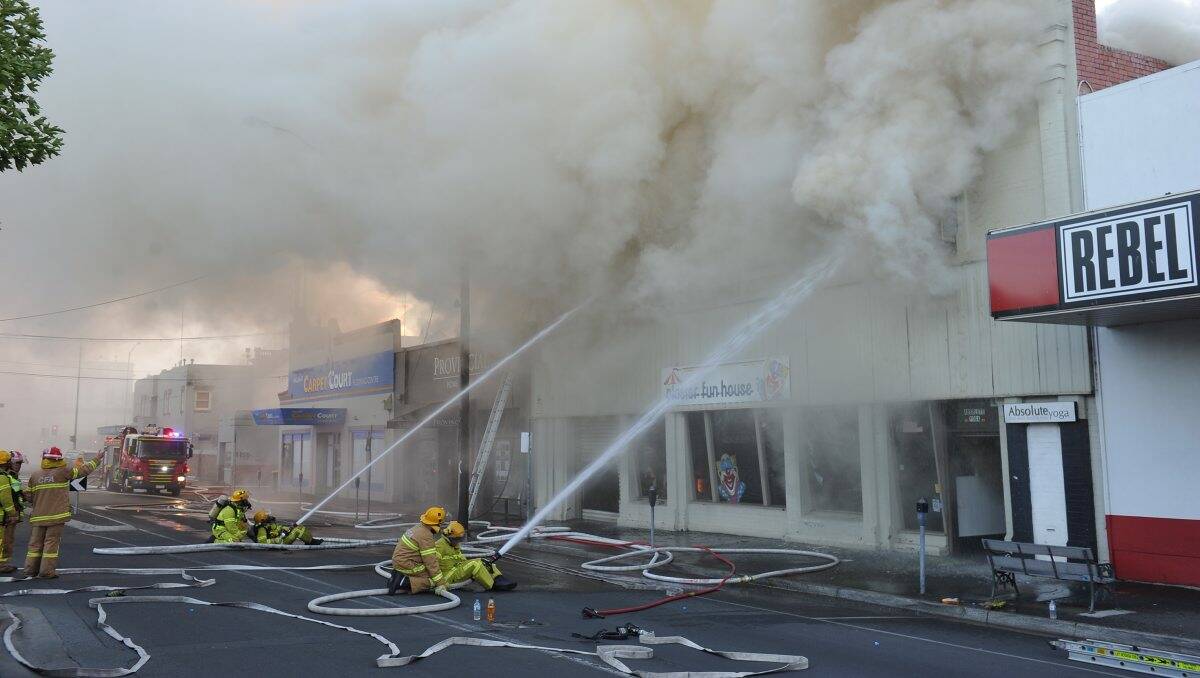 Firefighters battle last night's blaze as onlookers struggle believe their eyes. PIC: Lachlan Bence