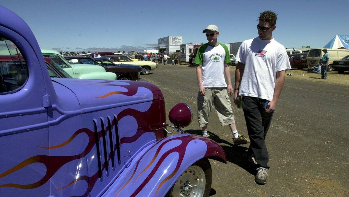 Year 2002. The 13th Super Southern Swap Meet at the Ballarat Airport. Colin Bruhn from Ballarat, left, and Brett McLeod from Ballarat, right, look at the 1934 Chev Tray on display. 
