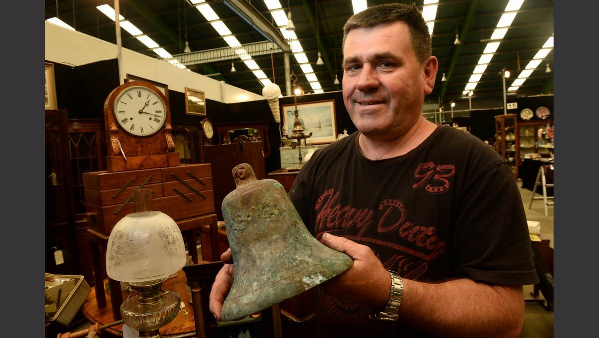 Craig Oliver  with a bell that was discovered underneath the Isle of White Resort Hotel in Phillip Island in 2012. The bell is from one of two shipwrecks located in the area. PIC: ADAM TRAFFORD
