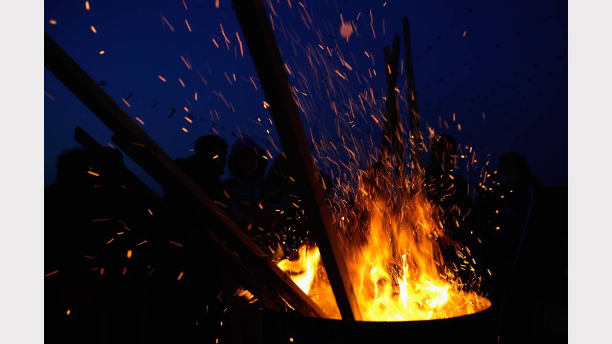 People gather around a fire. Photo Chung Sung-Jun