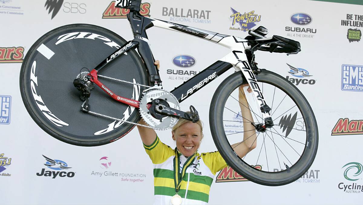 Felicity Wardlaw raises her bike after winning the elite women's time trial. PICTURE: CRAIG HOLLOWAY