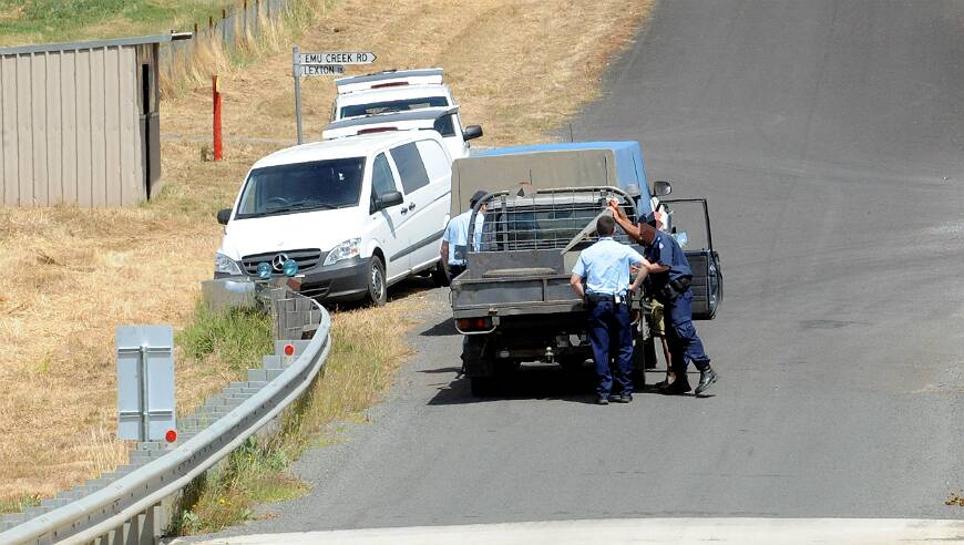Police inspect a passing vehicle outside Langi Kal Kal. PICTURE: JEREMY BANNISTER