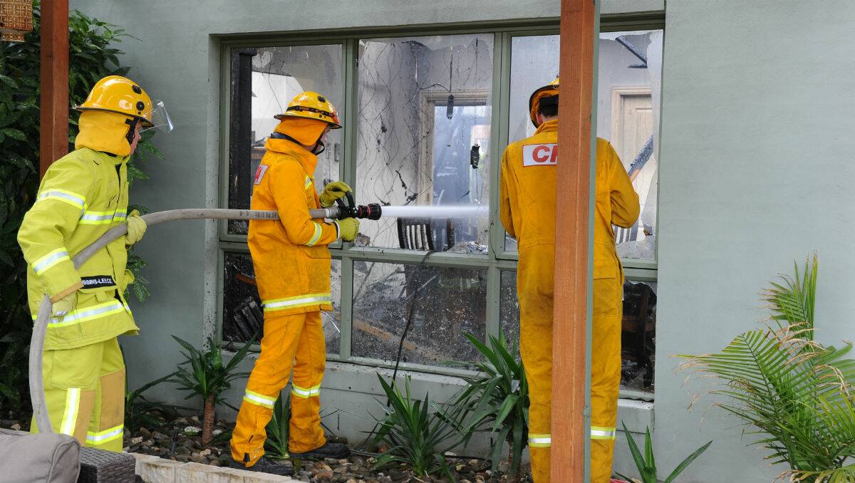 Firefighters battling the house fire at Milford Court in Invermay Park this afternoon. PICTURE: JUSTIN WHITELOCK