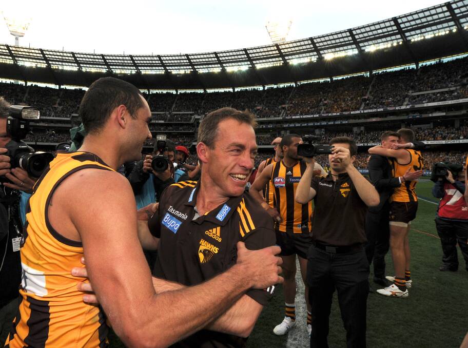 Shaun Burgoyne celebrates the 2013 AFL premiership with coach Alastair Clarkson, who has a link with Ballarat by boarding at the then Ballarat and Clarendon College in the early 1980s. He joins three other current or former AFL coaches with ties to the city.